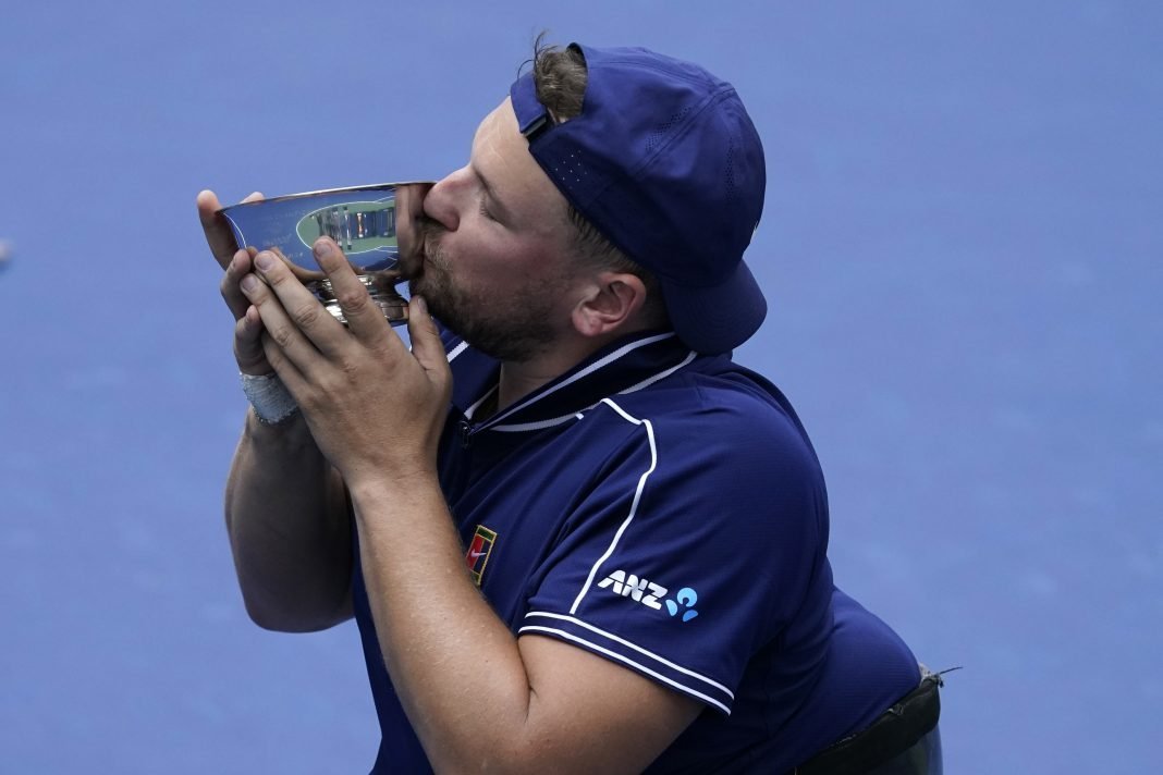 Wheelchair tennis ace Dylan Alcott kisses the US Open trophy after completing the 'golden slam'.
